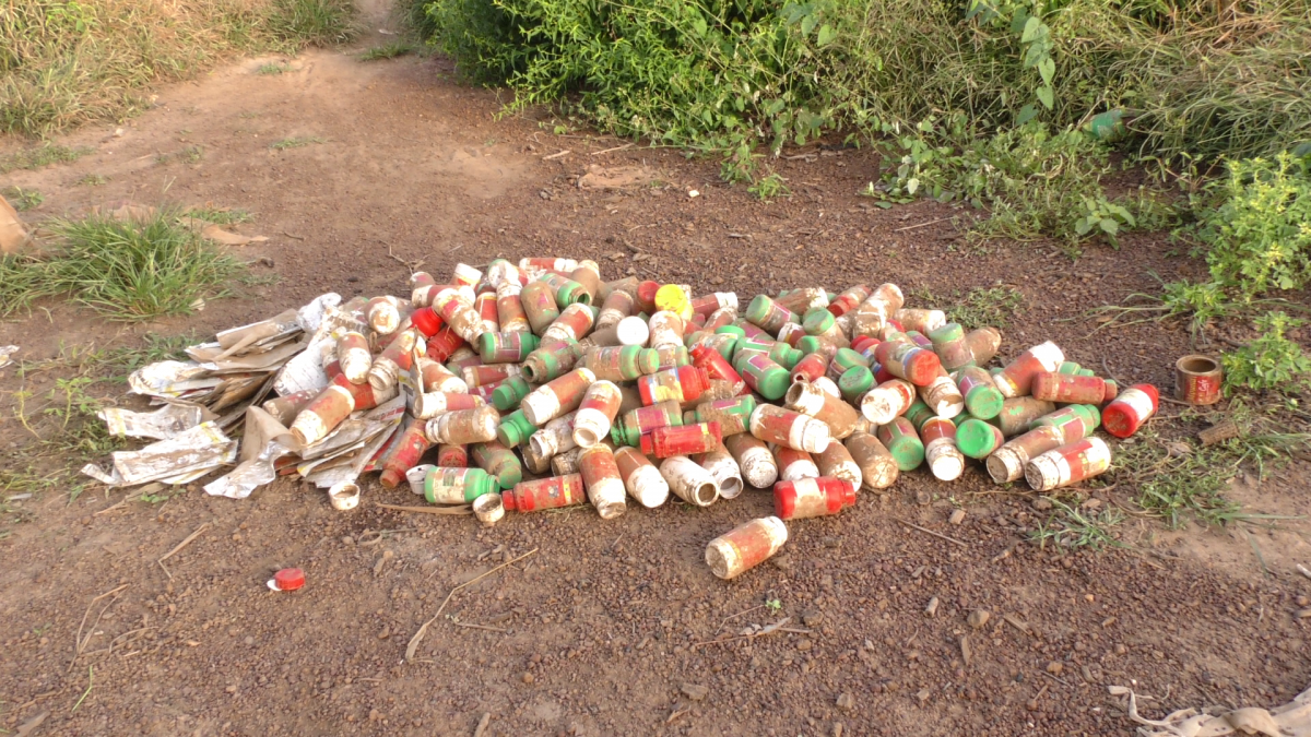 Empty pesticide containers in a Burkina Faso cotton field. Photo by Joseph Opoku Gakpo